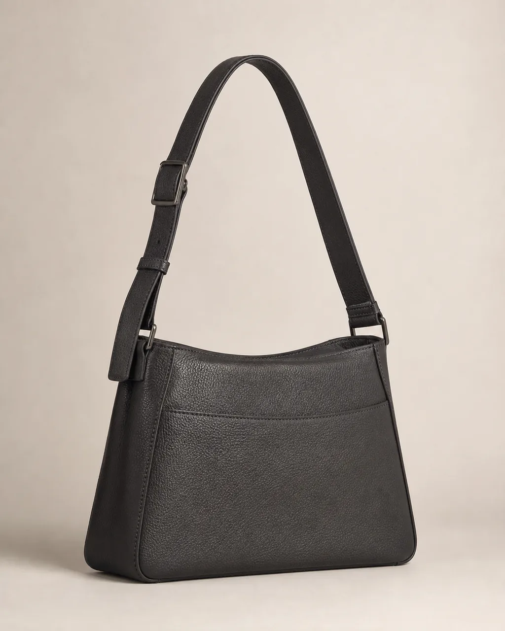 Original structured charcoal ORVEIL shoulder bag on a warm bone studio background